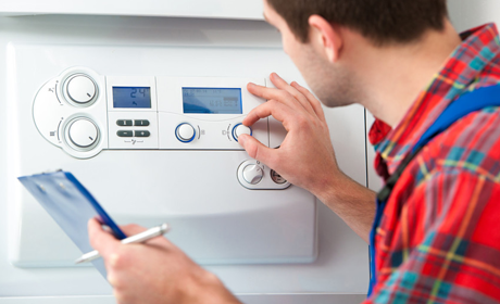 a serviceman checking the boiler to offer landlord certificate
