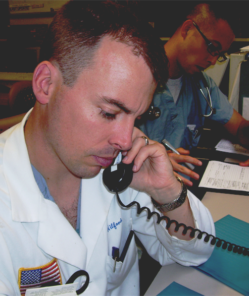 Photo of a man talking into a telephone.