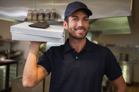 Smiling pizza delivery man holding two pizza boxes - Pizza Restaurant in Philadelphia, PA Smiling pizza delivery man holding two pizza boxes - Pizza Restaurant in Philadelphia, PA