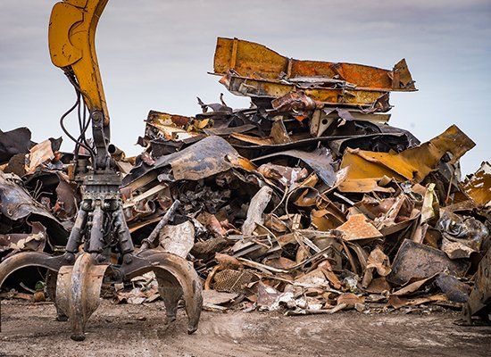 Metal Recycling Near Me — Large Tracked Excavator Working A Steel Pile At A Metal Recycle Yard In Huntington, WV Metal Recycling Near Me — Large Tracked Excavator Working A Steel Pile At A Metal Recycle Yard In Huntington, WV