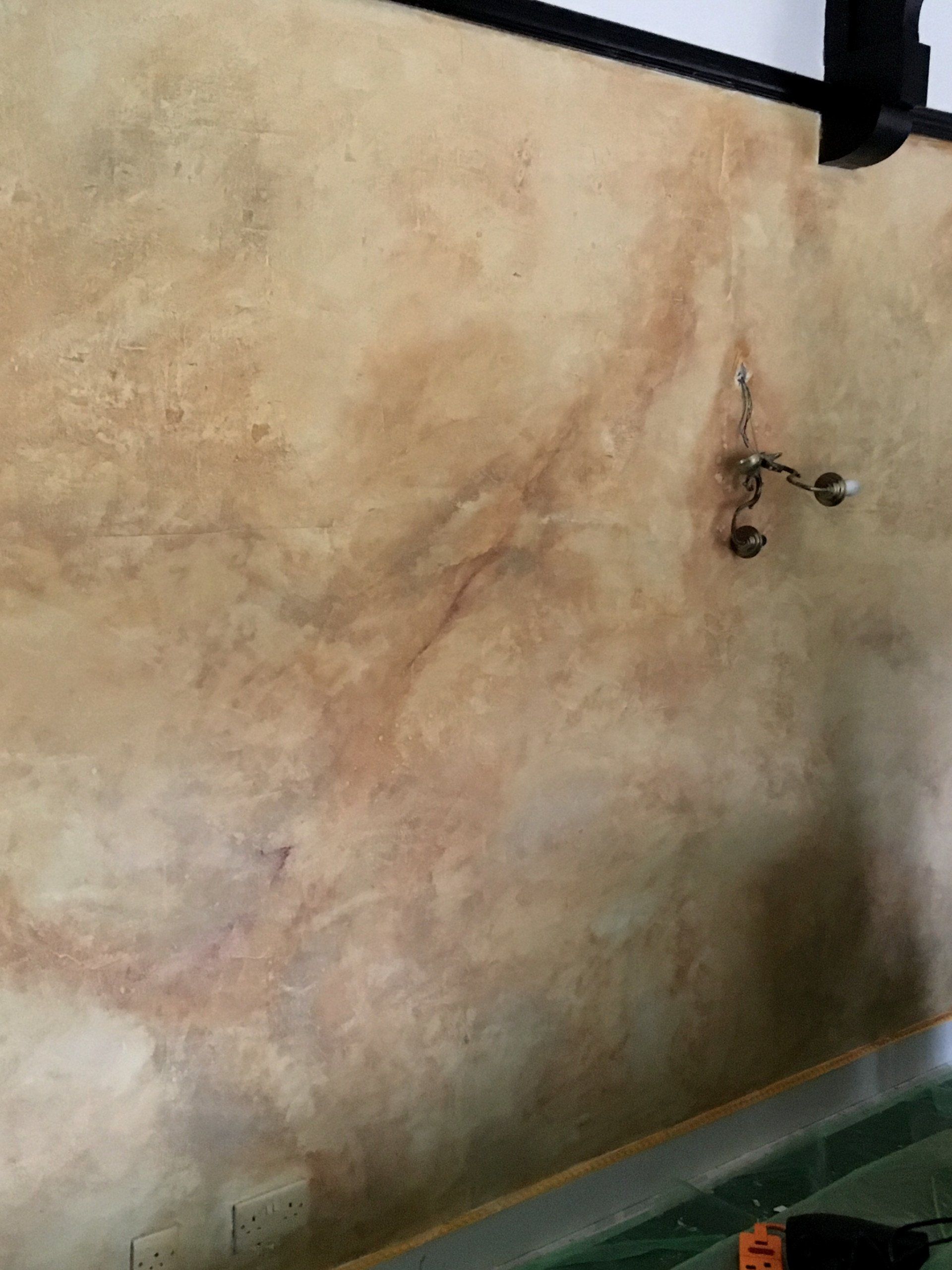 A close up of a wall with a drill on it.