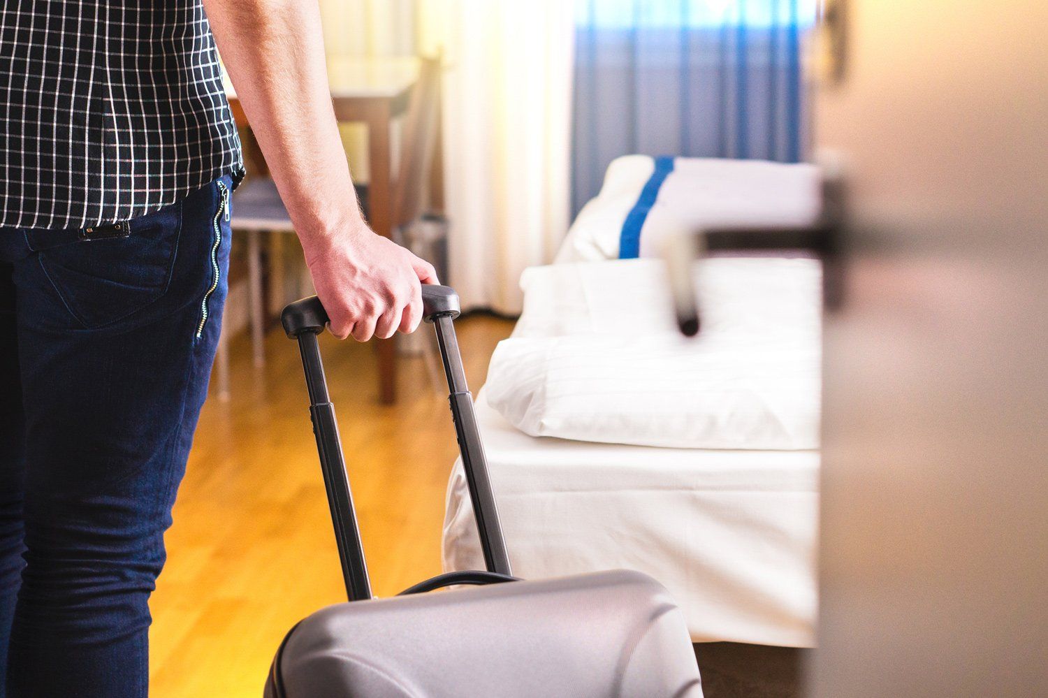Man Pulling Bag To New House— Louisville, KY — Montgomery Realtors
