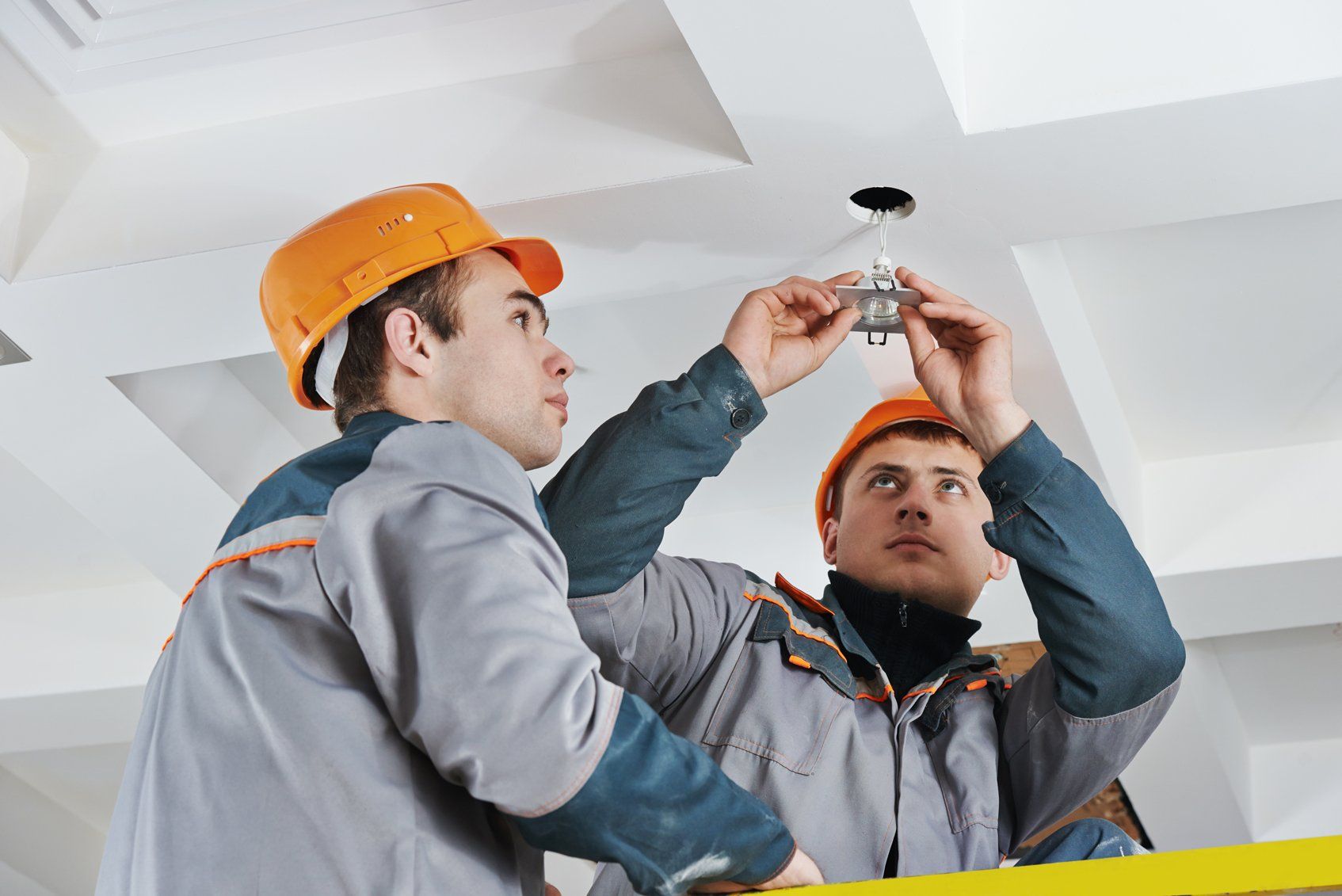 electrician worker in uniform installing