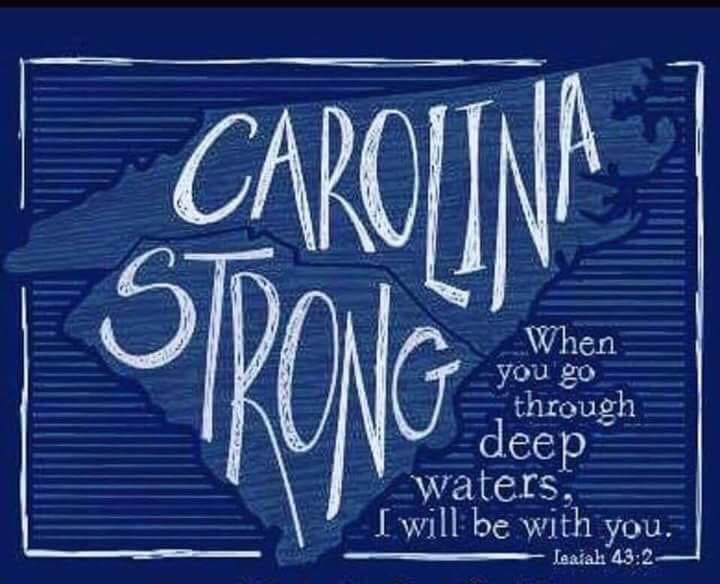 Blue sign with white text: “Carolina Strong” and a Bible verse about deep waters and being with you.