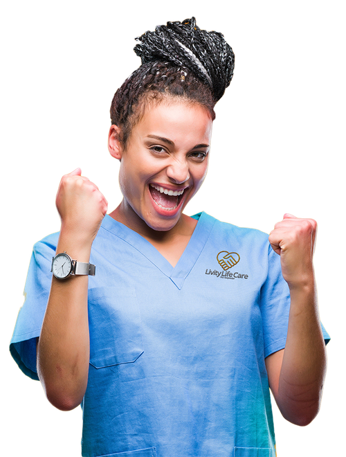 Livity Life Care Care Provider A Livity Life Care care provider in a blue scrub is holding her fist in the air and smiling.