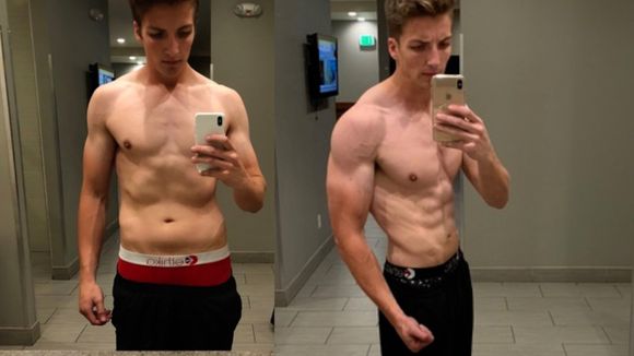 Two men are taking a selfie in front of a mirror.