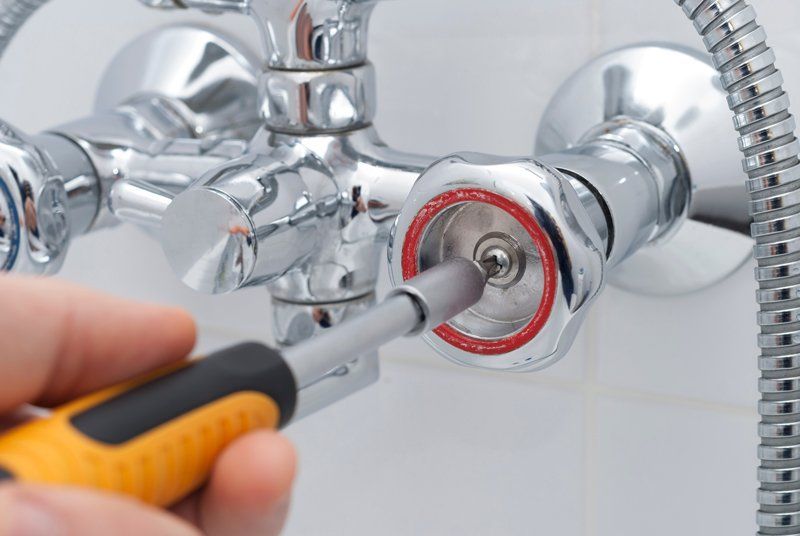 Plumber Repairs The Faucet In The Bathroom — KNP Plumbing and Gas — Airlie Beach, QLD Plumber Repairs The Faucet In The Bathroom — KNP Plumbing and Gas — Airlie Beach, QLD