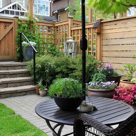 backyard nicely landscaped with privacy screen surrounding porch