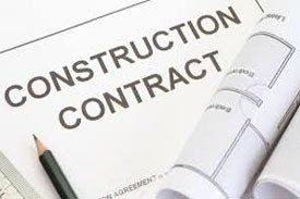 Construction contract document with rolled-up blueprints and a pencil, indicating a project's legal and design elements.