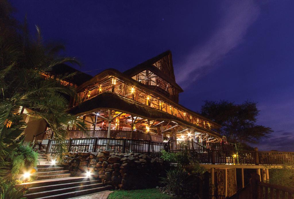 A large wooden building is lit up at night