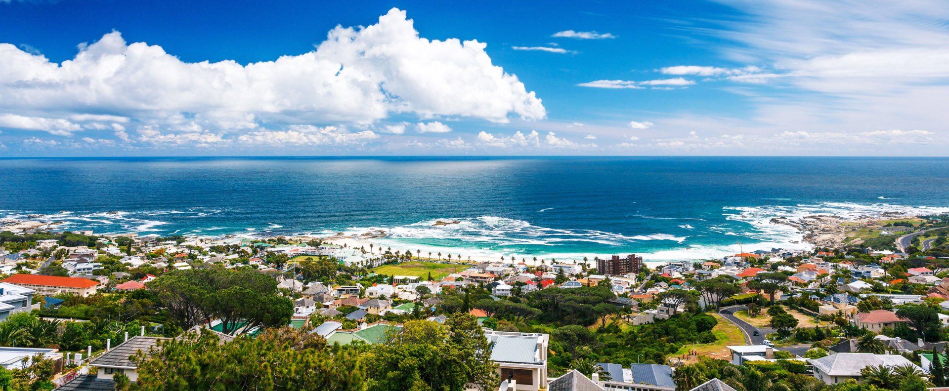 An aerial view of a city next to the ocean.