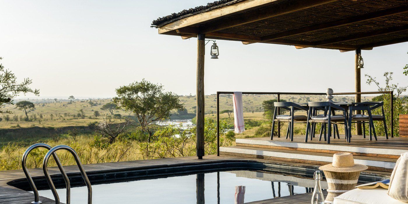 A swimming pool with a view of a lush green field