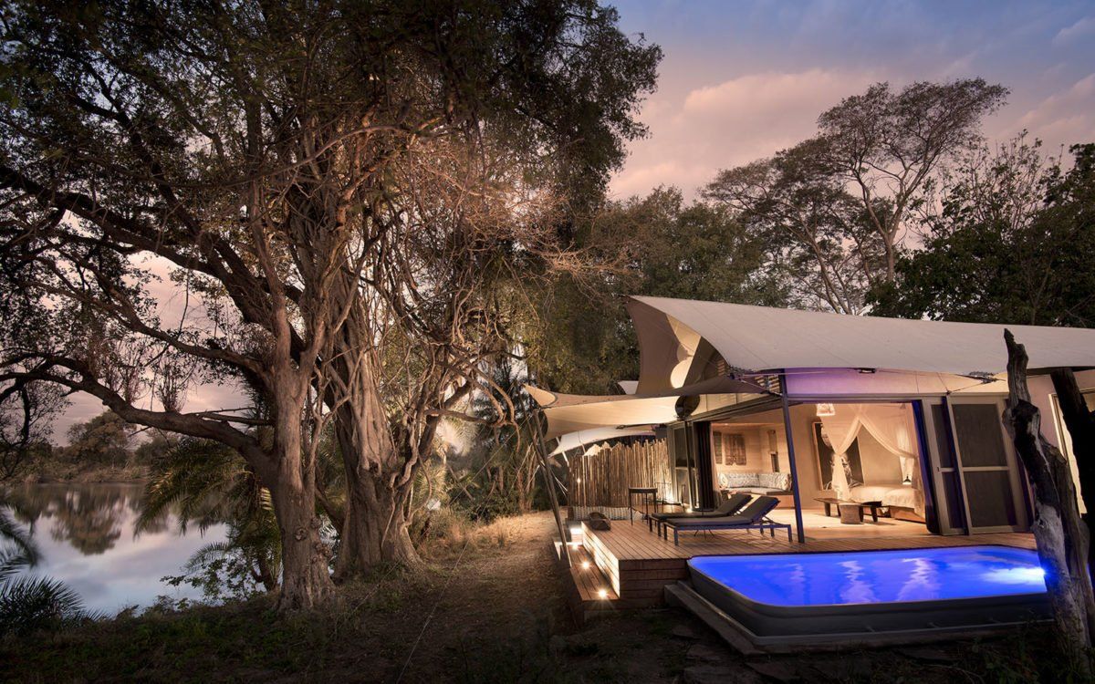 A house with a swimming pool in front of it