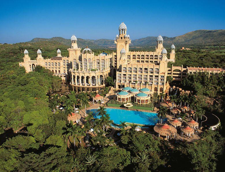 An aerial view of a large building with a large pool in front of it