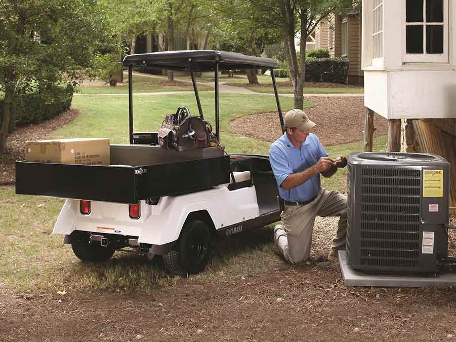 Golf Cart Repair — Golf Cart With HVAC Worker in Reno, NV