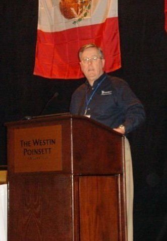 A man stands behind a podium that says the westin poinsett