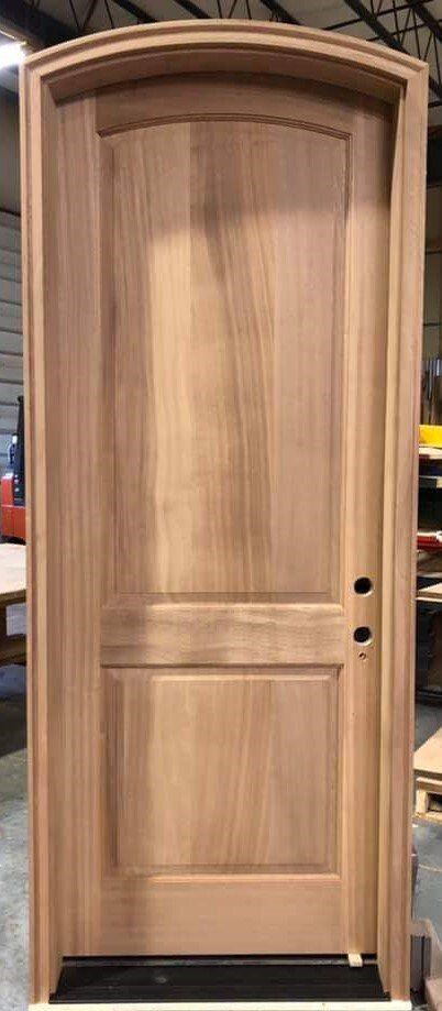 A wooden door is sitting on a table in a room.