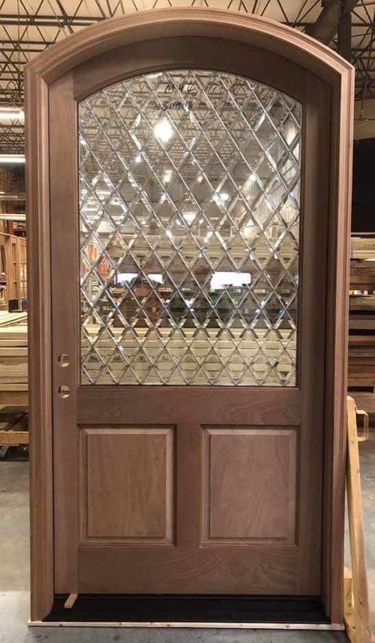 Eyebrow top exterior mahogany door with diamond beveled glass top panel