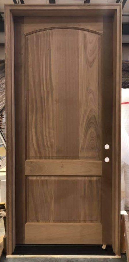 A wooden door is sitting on top of a table in a room.