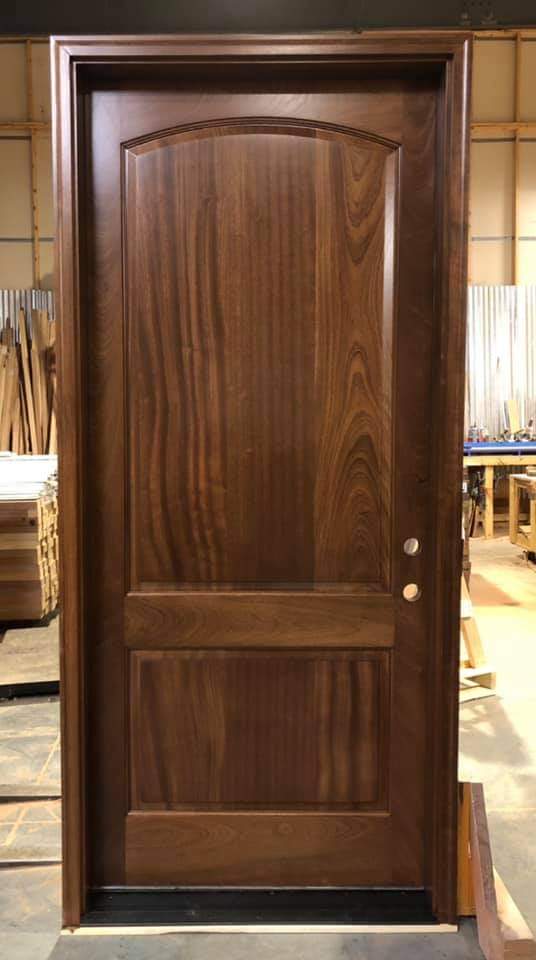 Solid mahogany exterior door with arched top panel factory finished