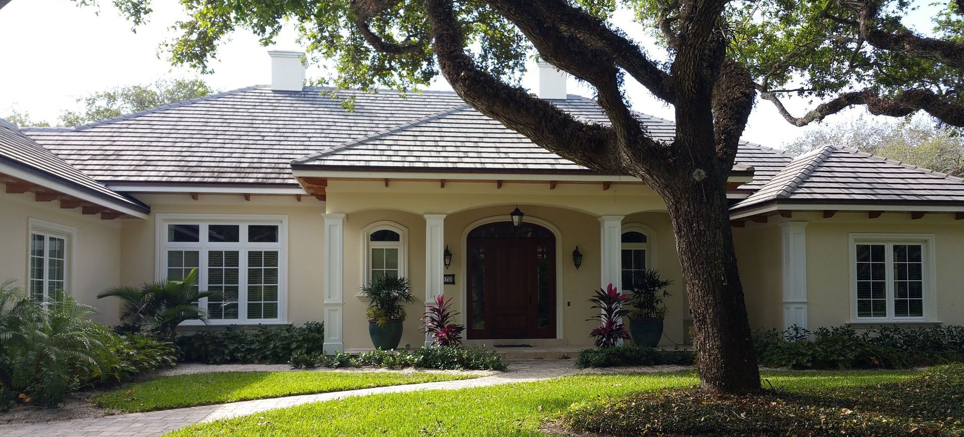 A large house with a tree in front of it