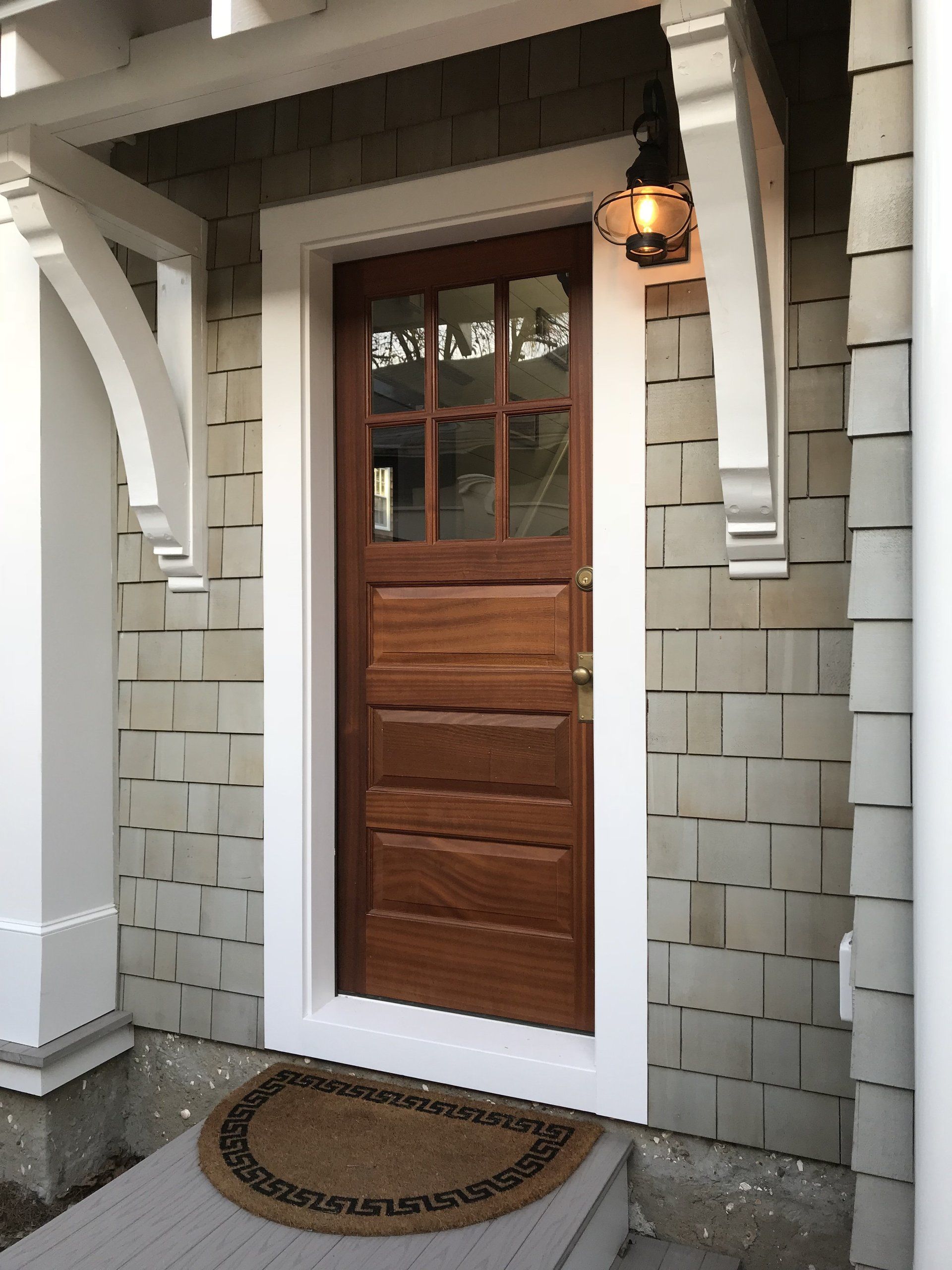 The front door of a house has a rug on it