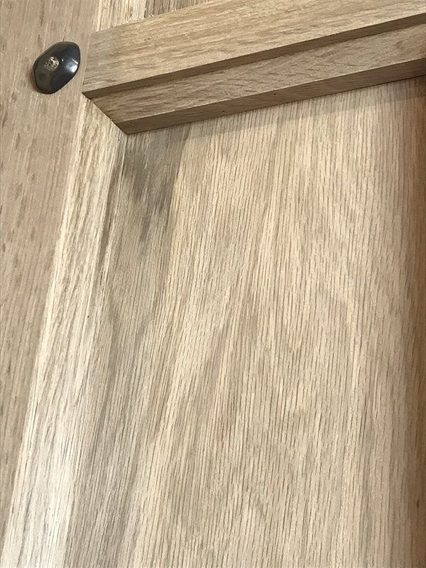 A close up of a piece of wood with a screw in it.