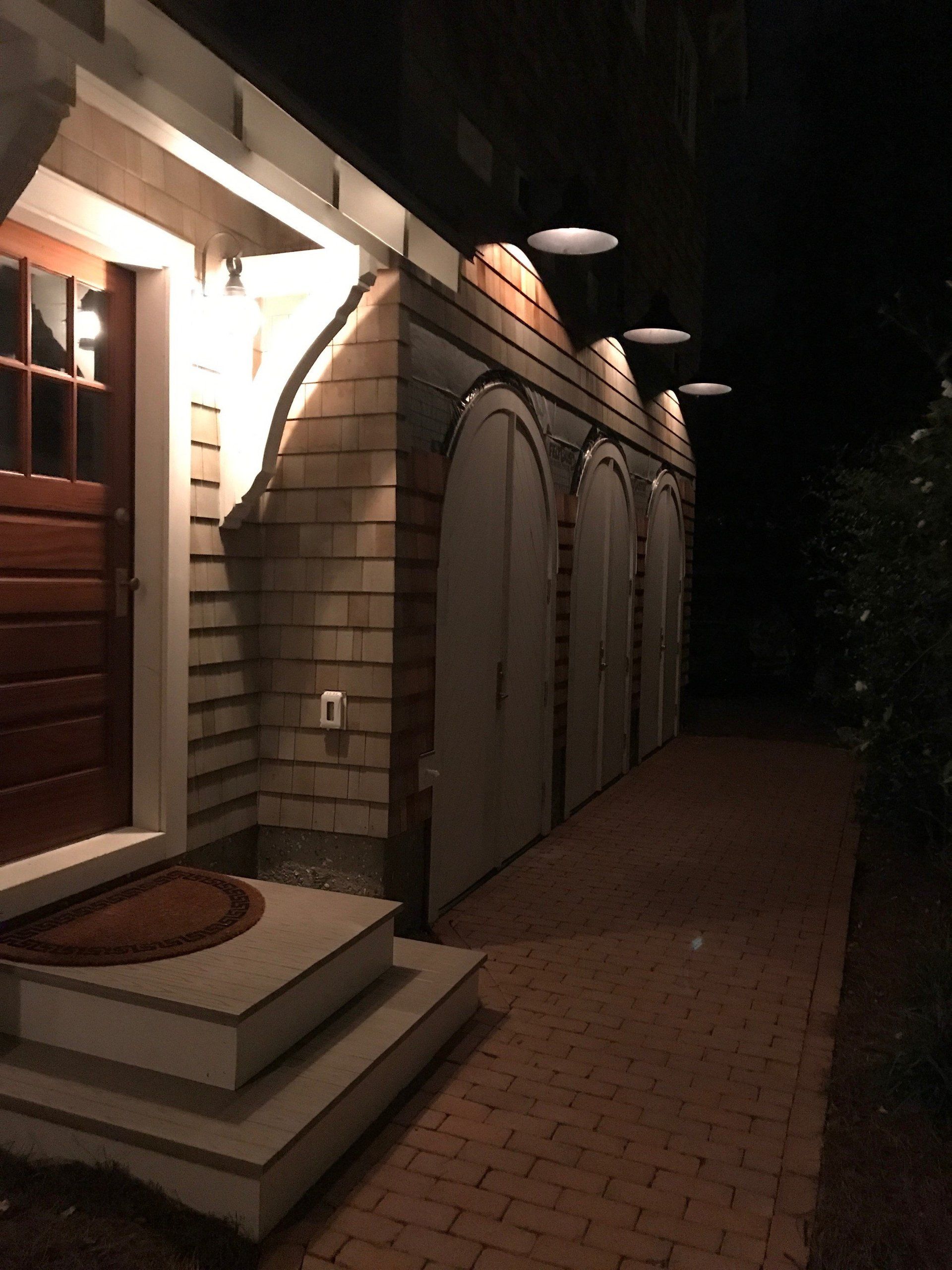 A row of garage doors are lit up at night