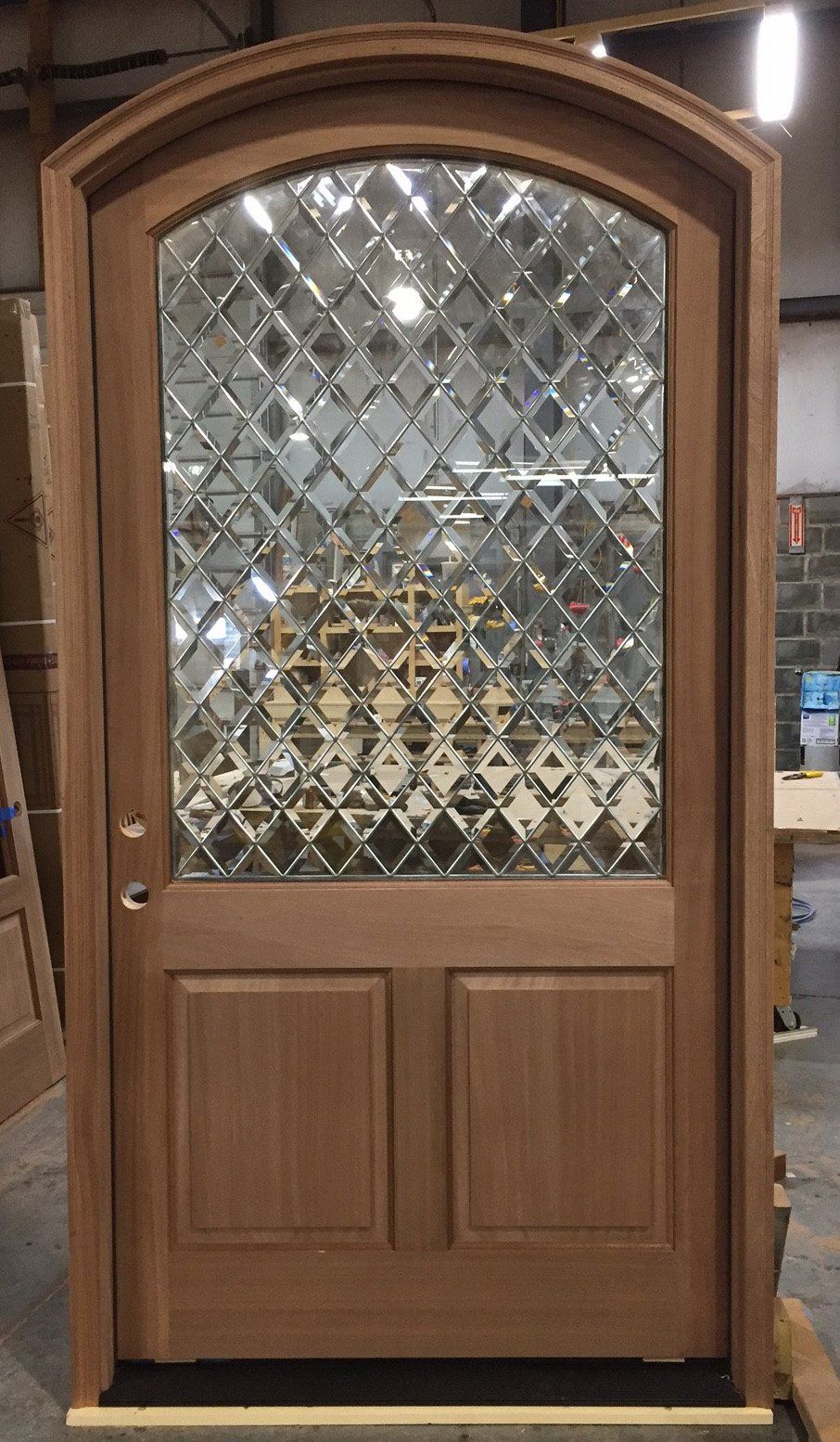 Sapele Mahogany arch top door with beveled diamond glass.
