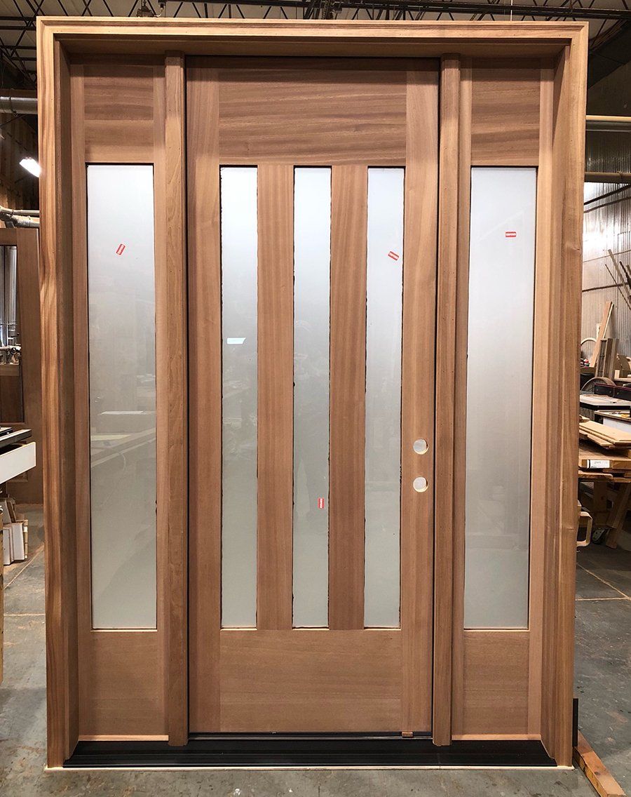 Modern front door with 3 vertical panes of frosted glass and two matching sidelites
