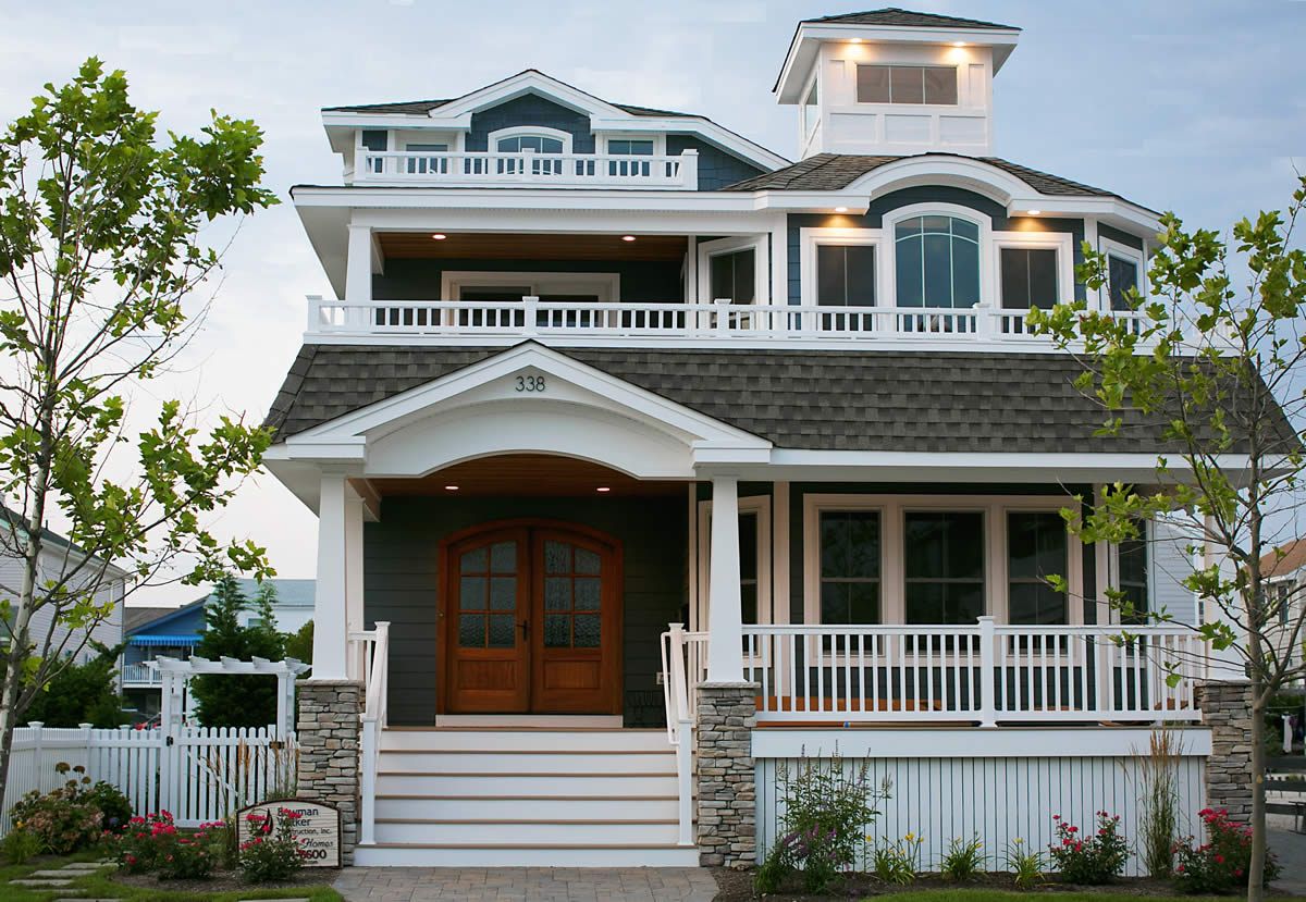 A large house with a large porch and stairs