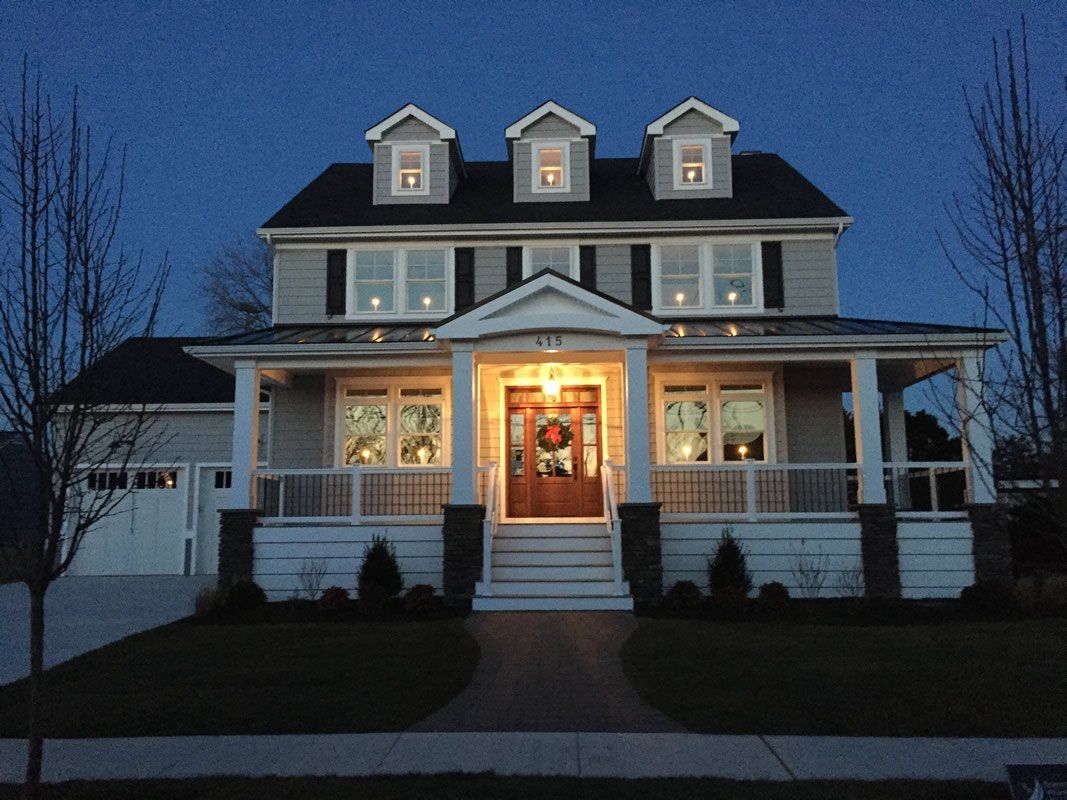 The front of a house is lit up at night