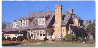 A large house with a lot of windows and chimneys