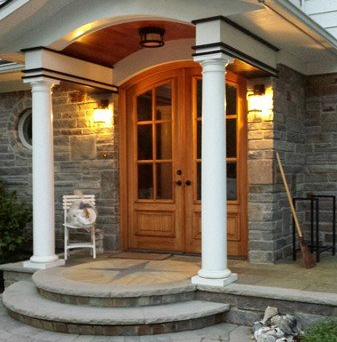 A porch with a chair and a broom on it