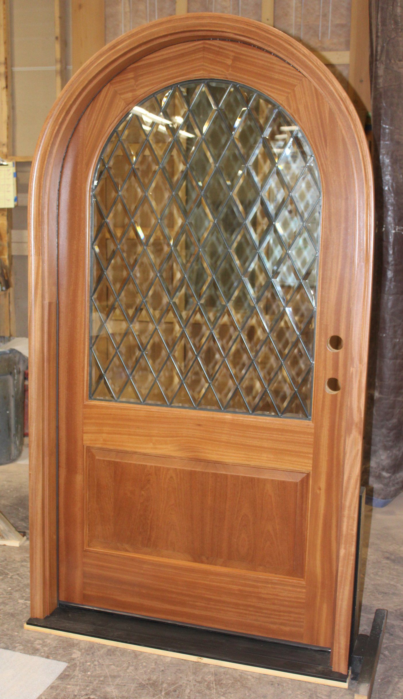 Round top mahogany door factory finished with beveled beveled glass.