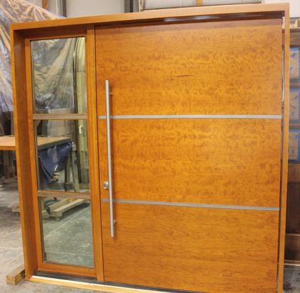 A large wooden door with a glass window
