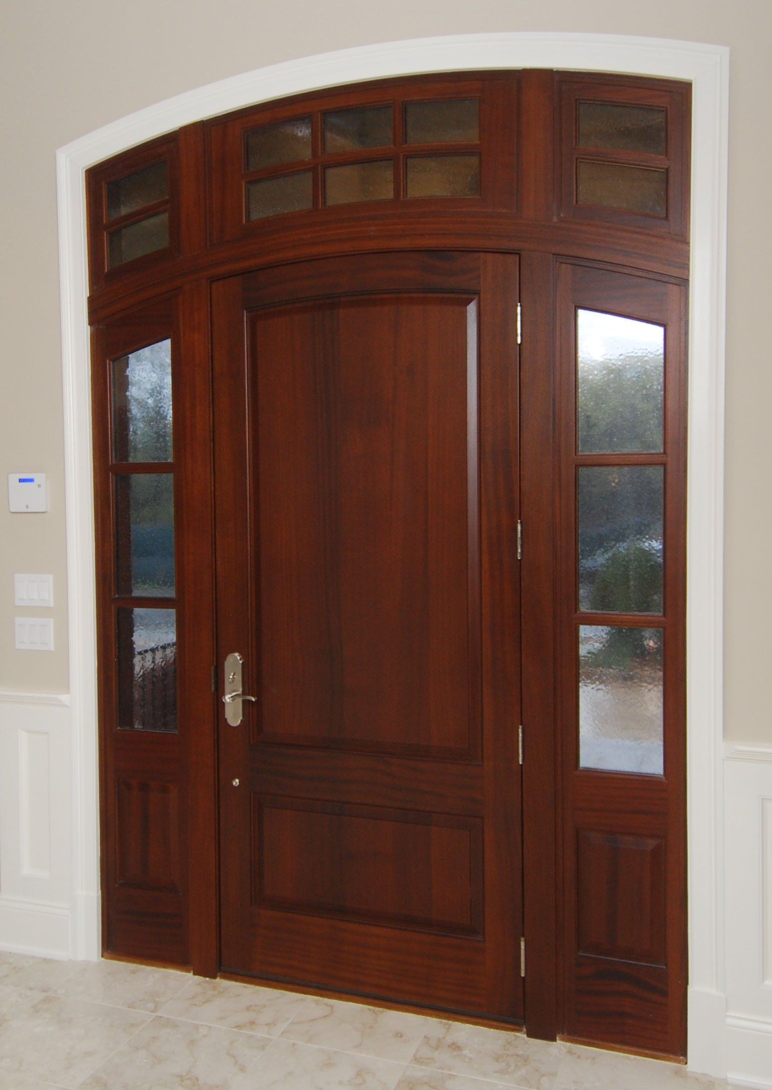 Arch top solid wood door with side windows and transom