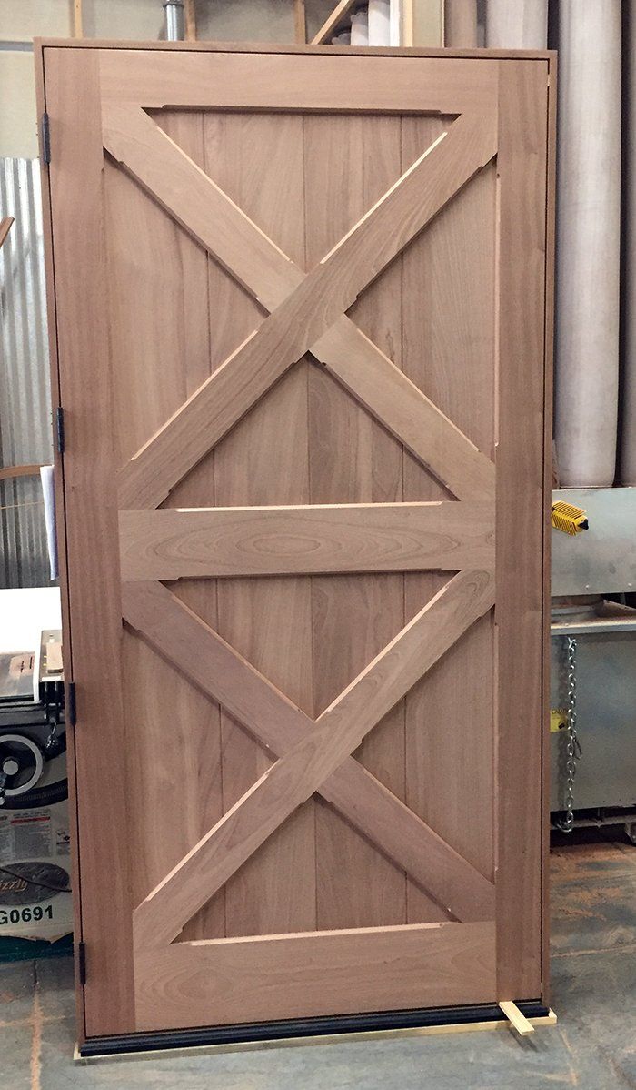 A wooden door with a cross design on it