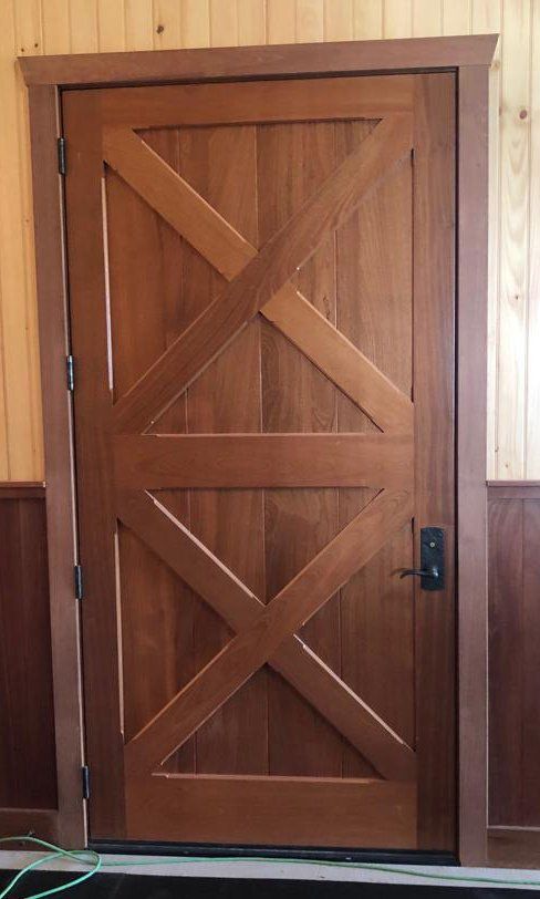 A wooden door with a cross design on it