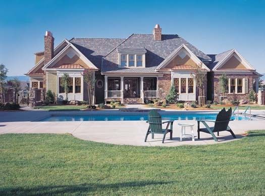 A large house with a swimming pool in front of it