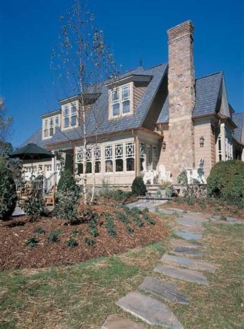 A large house with a stone walkway leading to it