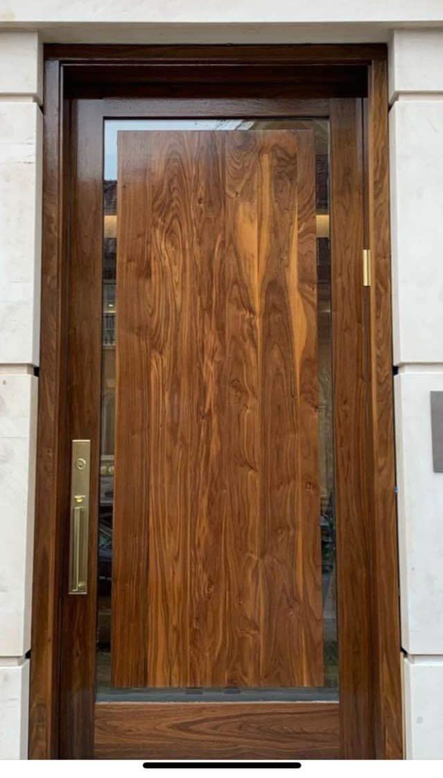 Unique modern Black Walnut entry door with thin glass surround