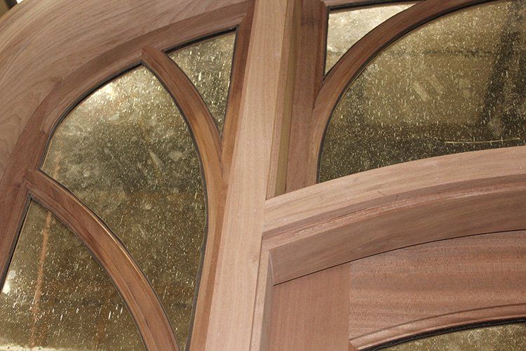 A close up of a wooden window with Seeded glass