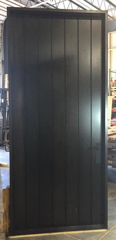 Modern dark stained mahogany exterior planked panel door