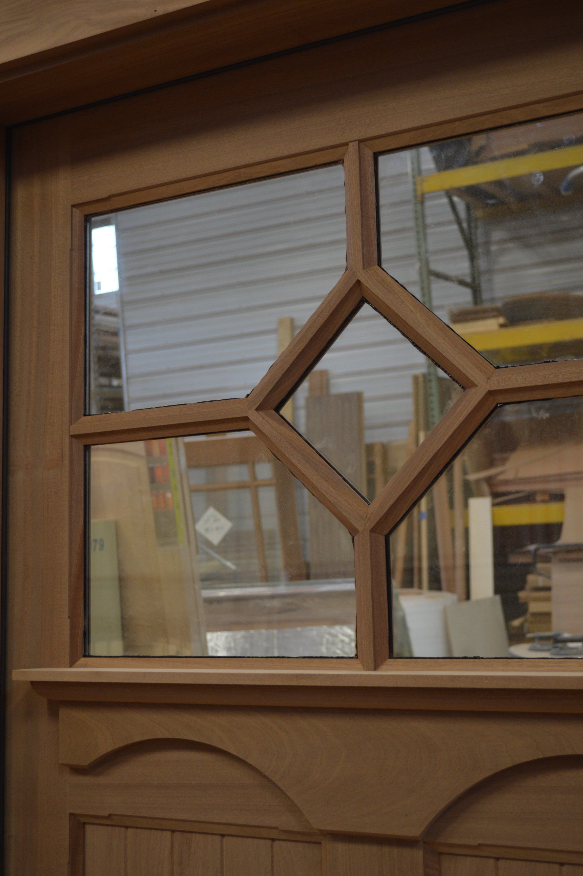 A close up of a wooden door with a glass window