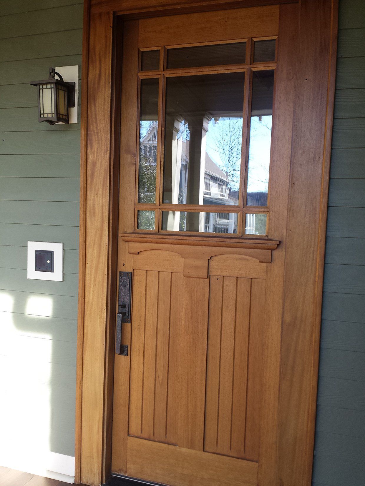A wooden door with a light on the side of it