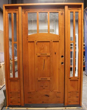 A large wooden door is sitting on a pallet in a room