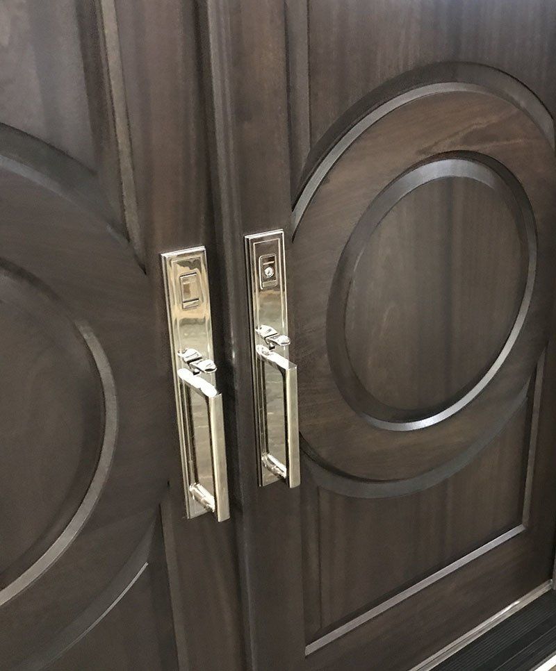 A close up of a wooden door with round handles