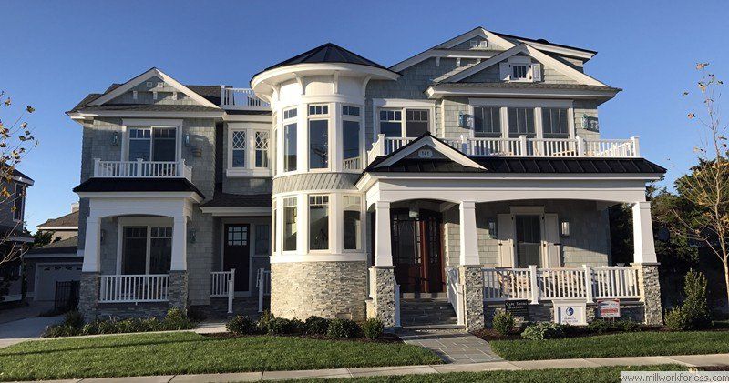 A large house with a lot of windows and a porch.