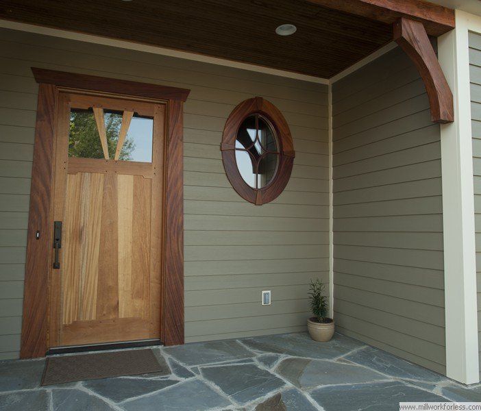 A house with a wooden door and a round window